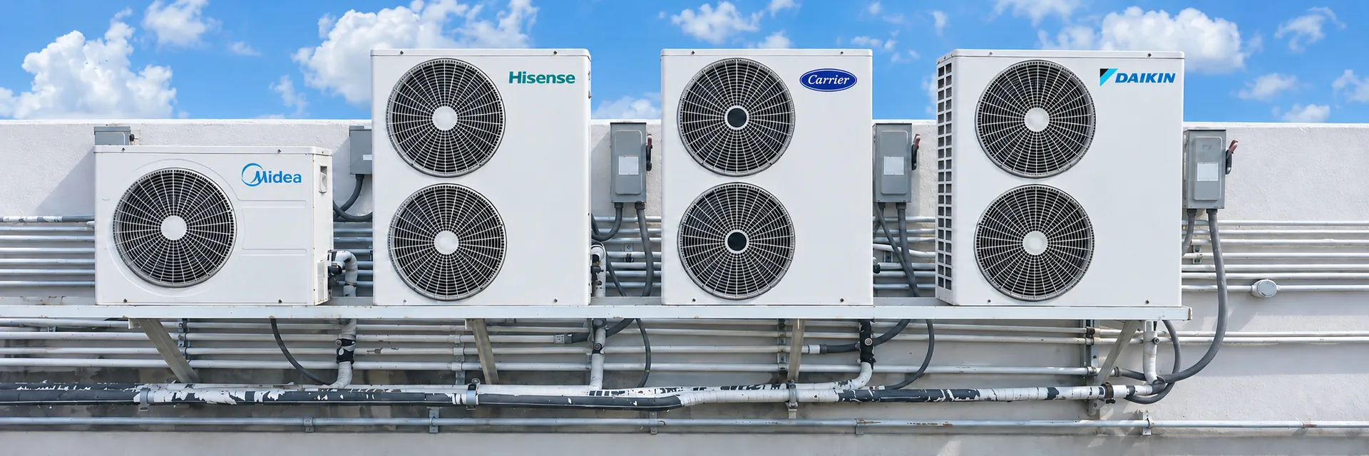 Four outdoor air conditioning units: Midea, Hisense, Carrier and Daikin, left to right