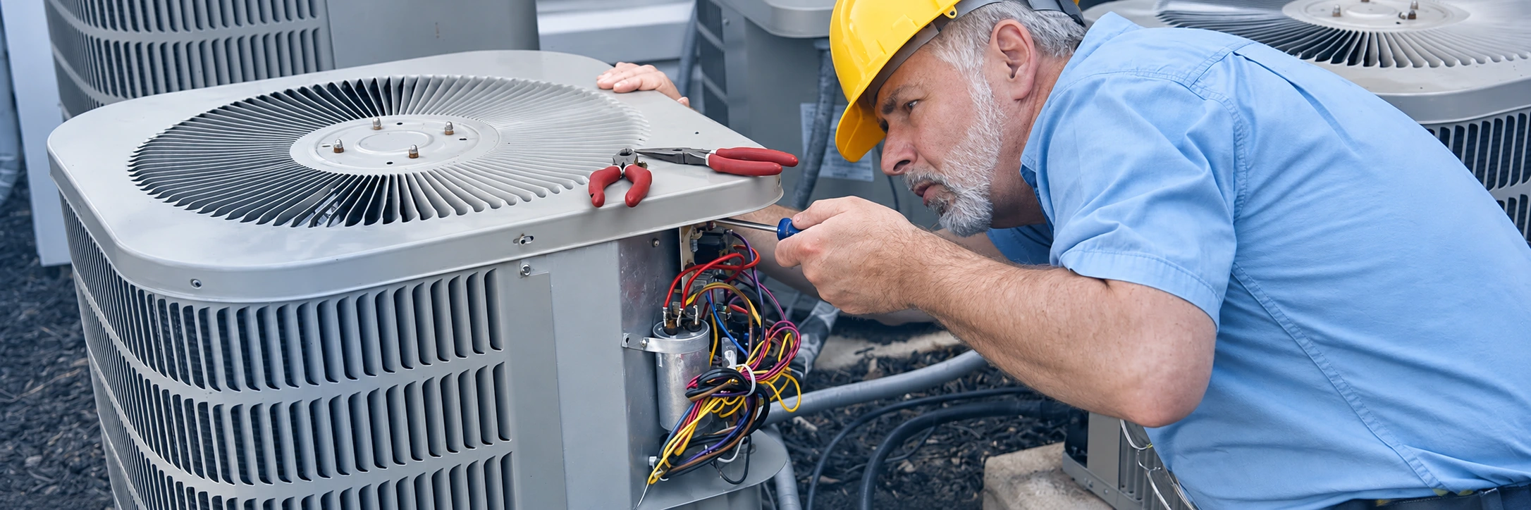 Air conditioning technician servicing an outdoor unit